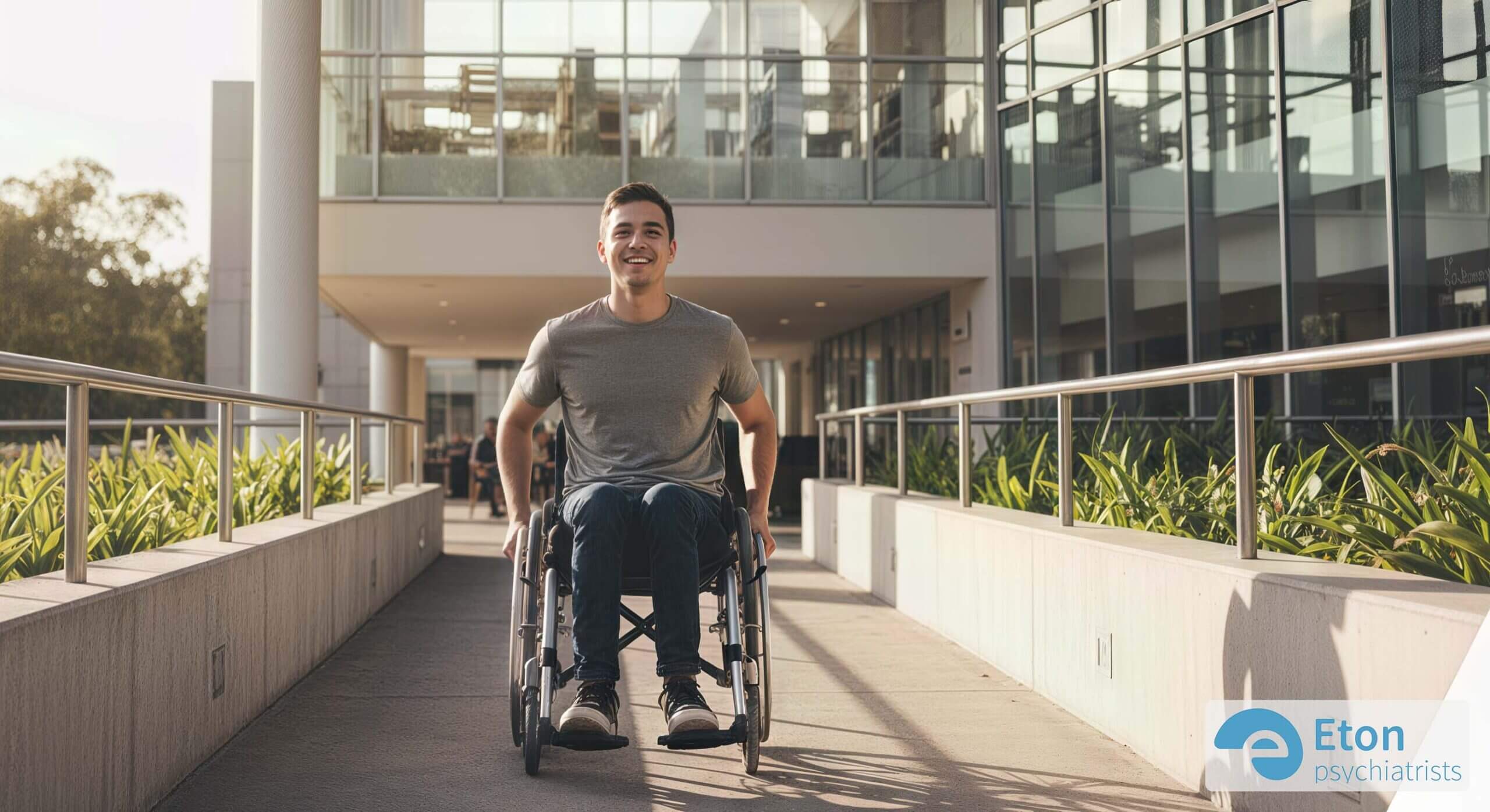 A man in a wheelchair smiling as he confidently uses an accessible ramp, illustrating the social model of disability.
