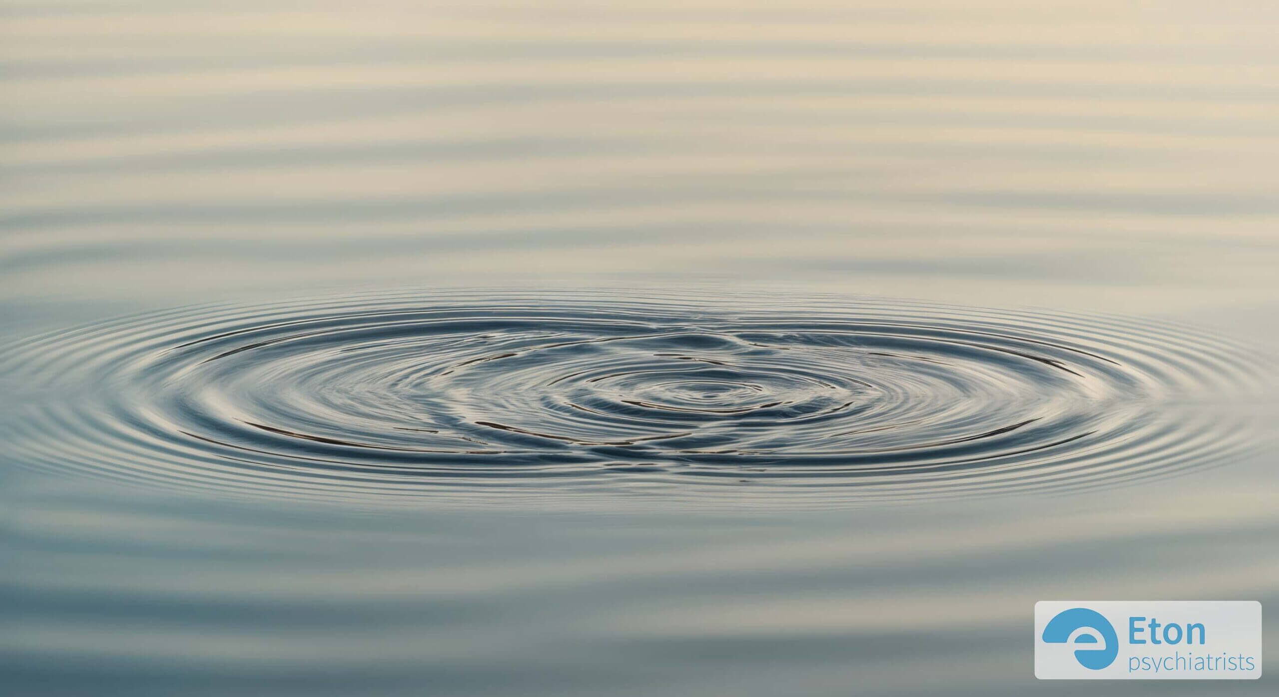 Overlapping ripples on calm water, symbolizing the concept of correlation rather than direct causation.