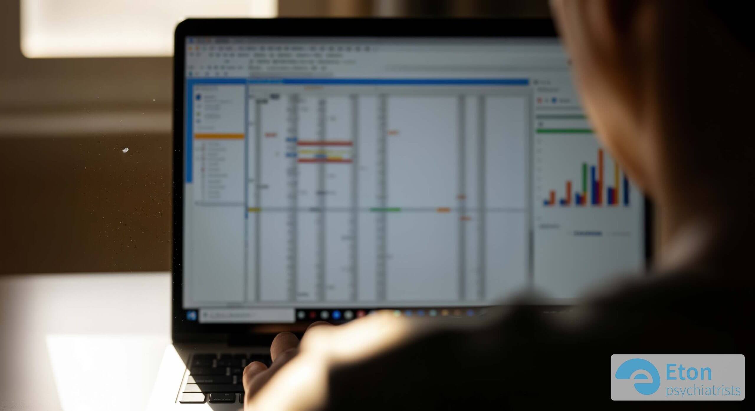 An over-the-shoulder view of a person at a desk where a tiny dust mote is in sharp focus, symbolizing a moment of unintended hyperfocus due to inattentive ADHD.