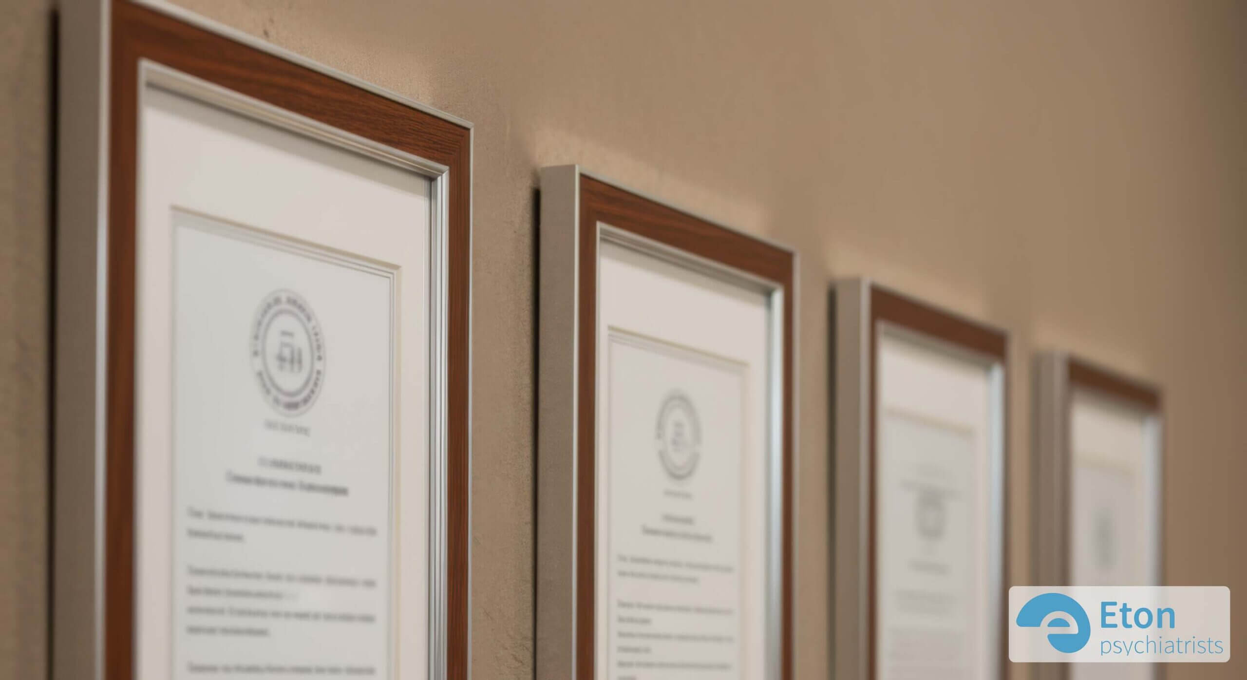 A close-up of a framed certificate on a clinic wall, symbolizing adherence to NICE guidelines and CQC regulation.