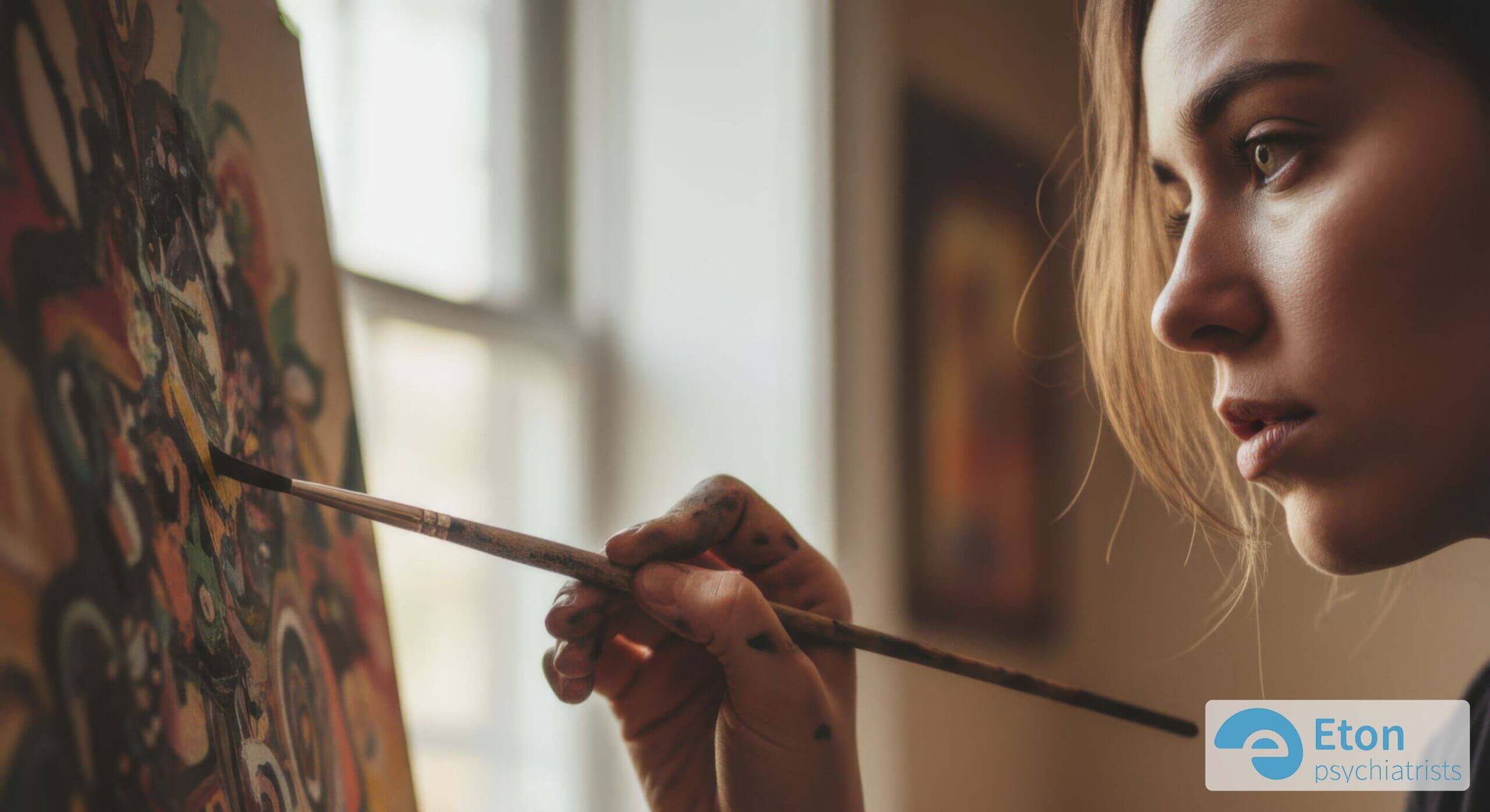 A person deeply absorbed in painting, demonstrating the intense concentration of ADHD hyperfocus.